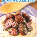 Brown sugar kielbasa on a bed of mashed potatoes.