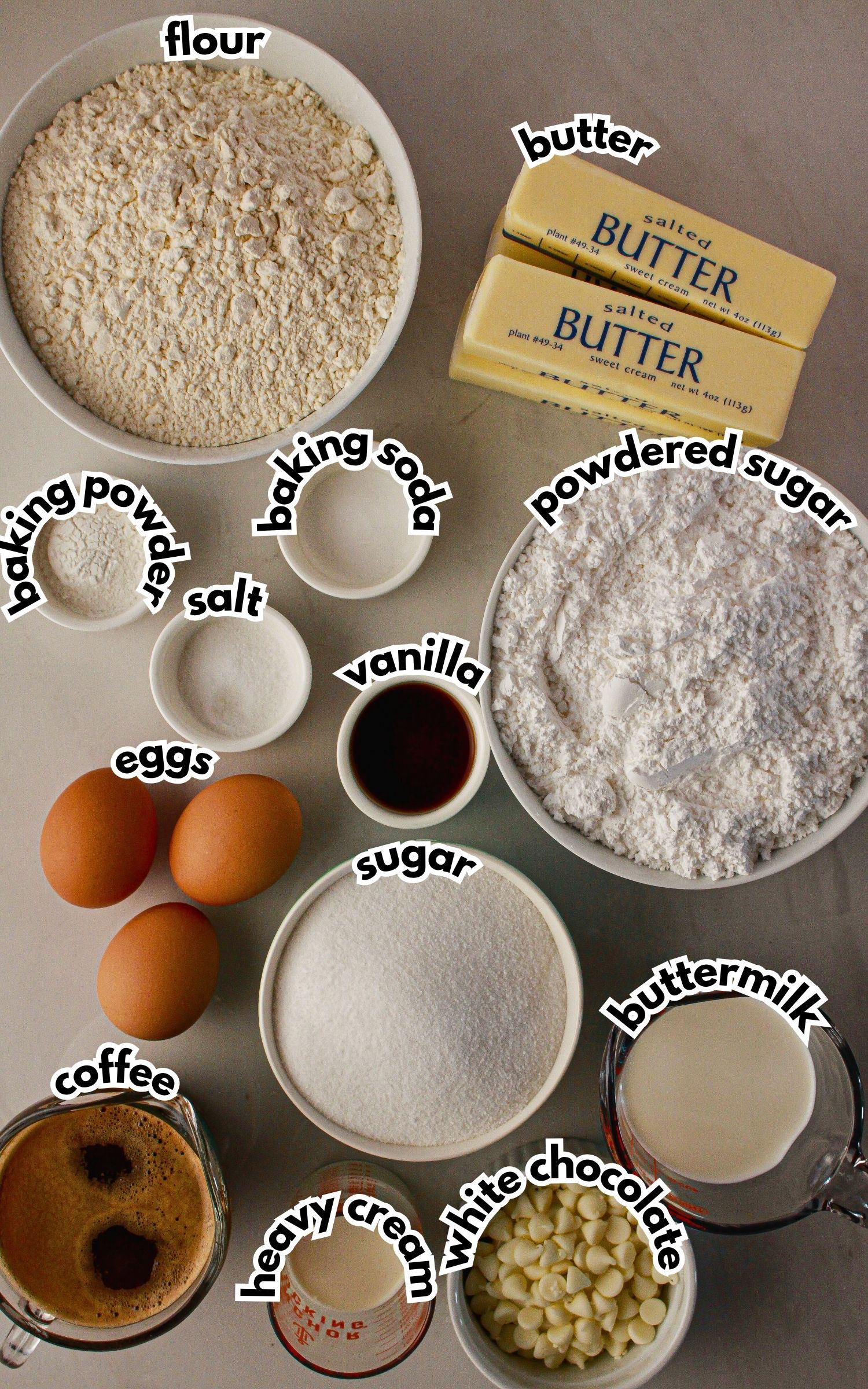 Bowls of ingredients labelled with text on a counter.