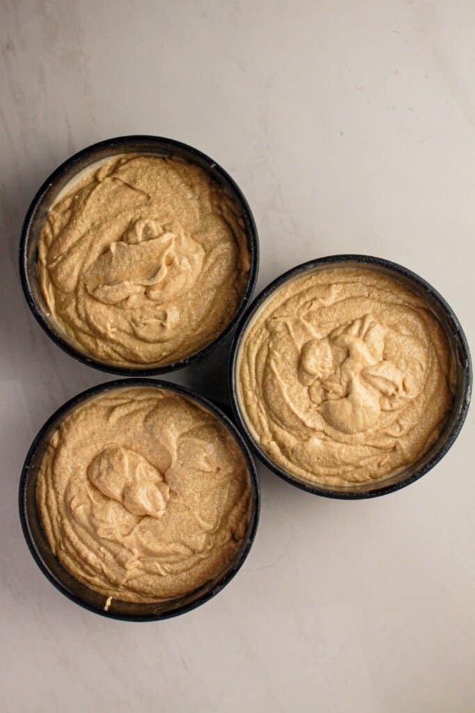 Batter in three round baking pans.