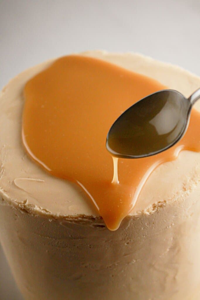 Ganache being poured on top of dessert.