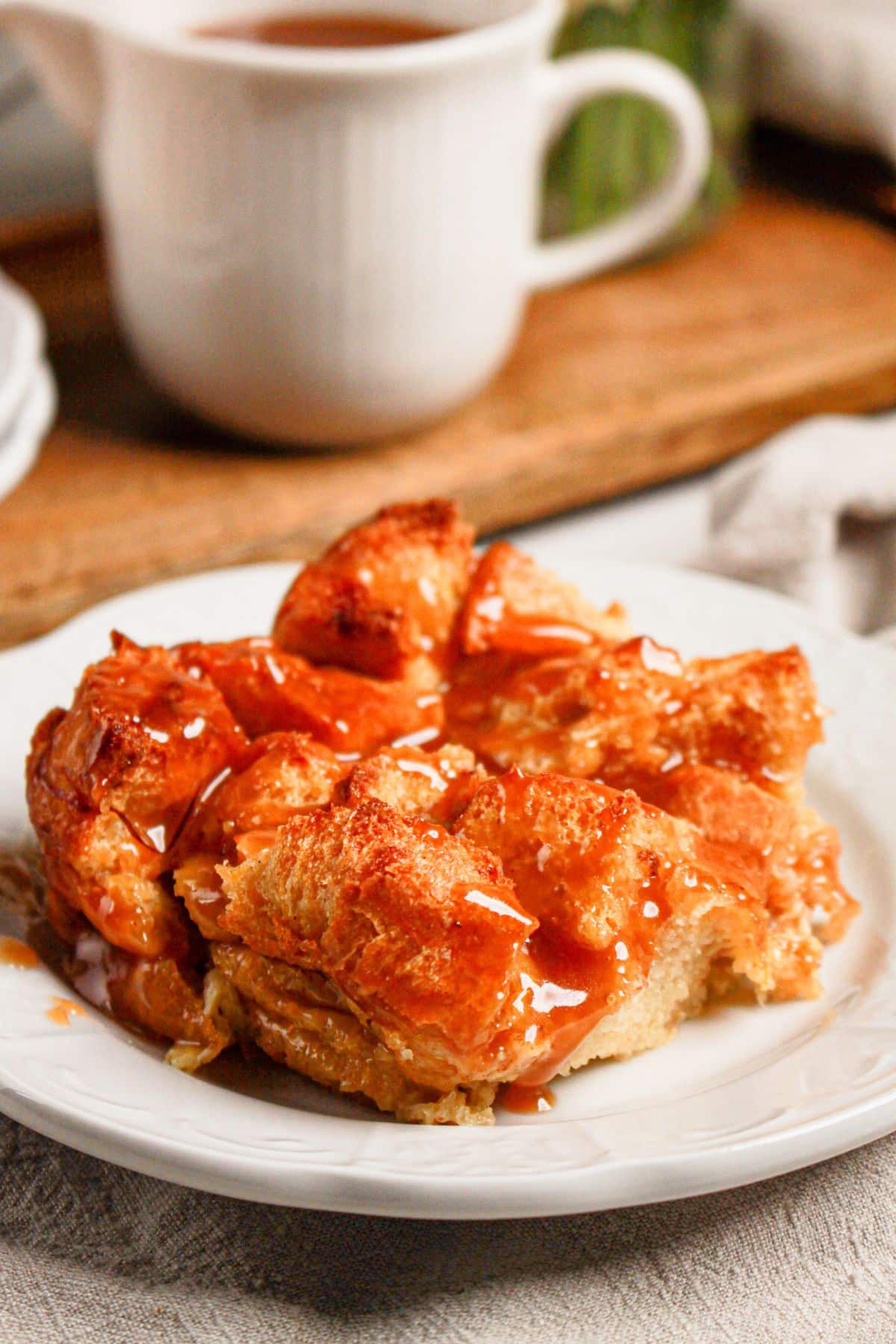 Caramel bread pudding in a white baking dish.