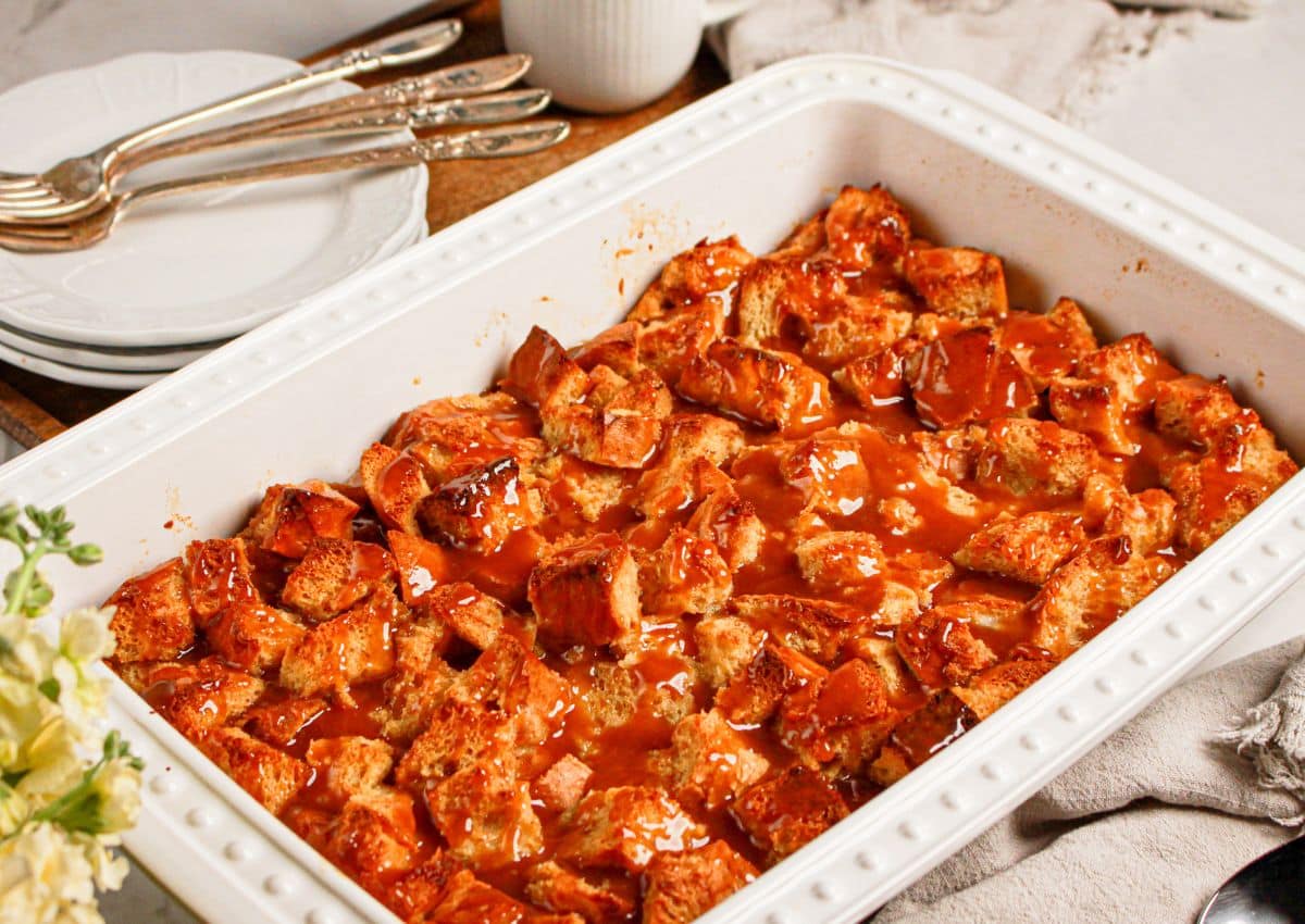 Caramel bread pudding in a white baking dish.