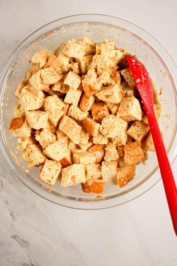 Pieces of bread being mixed in a mixing bowl.