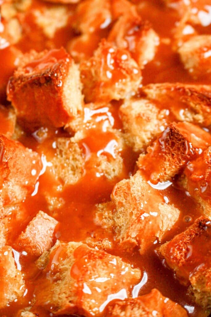 Caramel bread pudding in a white baking dish.