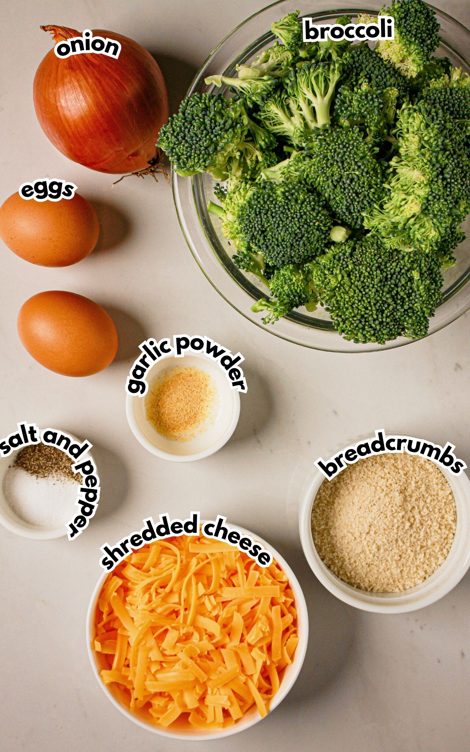Bowls of ingredients labelled with text on a counter.