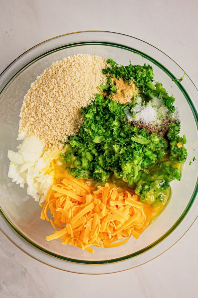 Ingredients being mixed together in a large glass bowl.