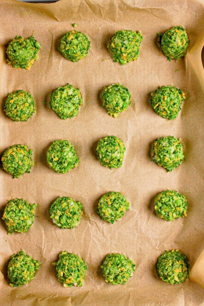 Vegetable balls on a parchment lined baking sheet.