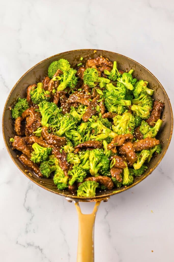 Wok full of beef and broccoli.