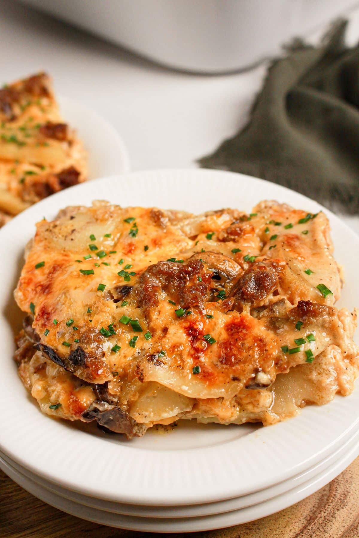 White plate with ground beef and potato casserole.