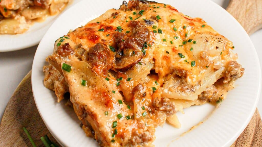 White plate with ground beef and potato casserole.