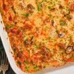 Cheesy Beef and Potato Casserole White baking dish full of cheesy food.