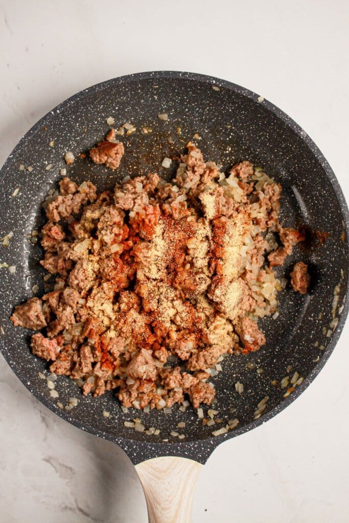 Meat being cooked in a skillet.