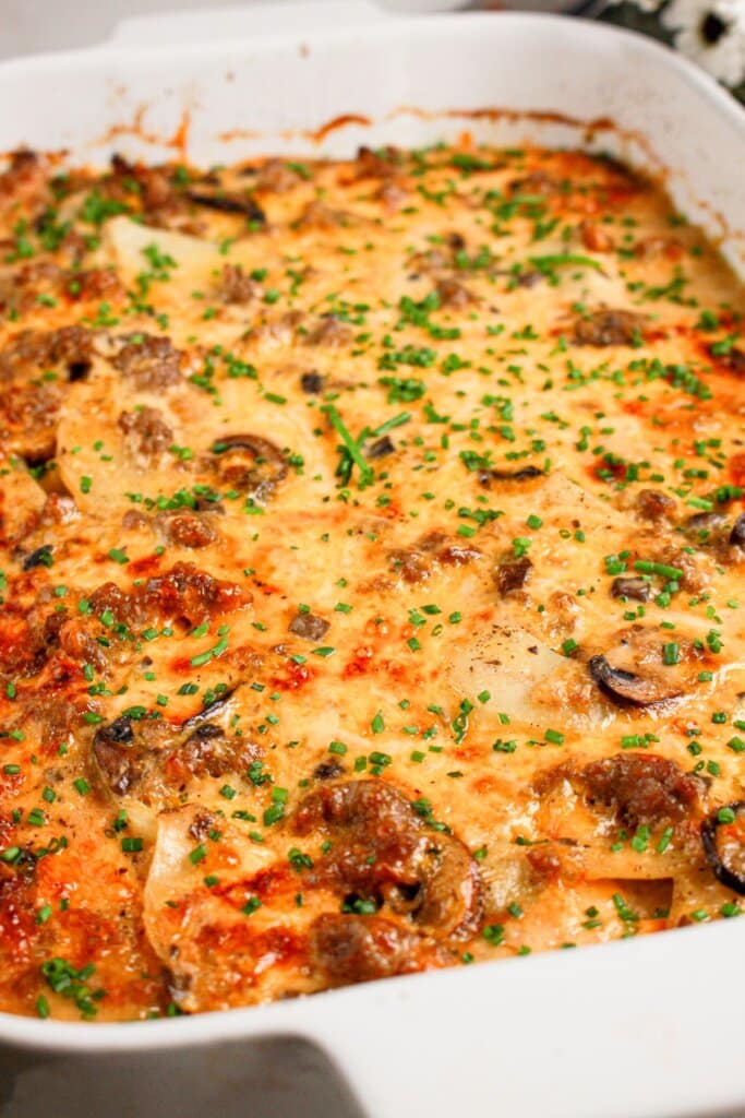 White baking dish topped with melted cheese.