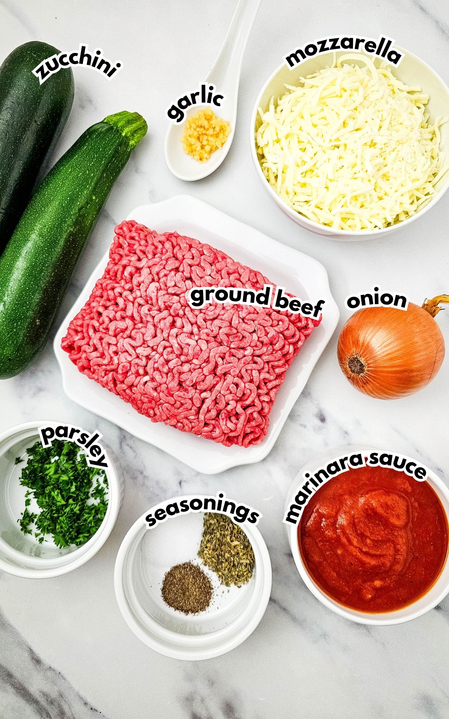 Bowls of ingredients labelled with text on a counter.