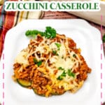 Ground beef and zucchini casserole on a white plate.