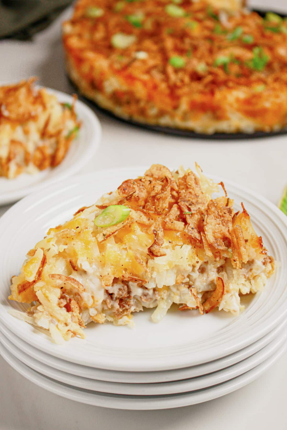 Slice of hobo casserole on a small white plate.