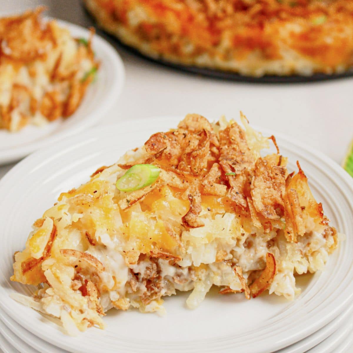 Slice of hobo casserole on a small white plate.