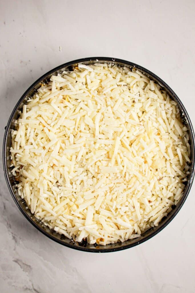 Frozen hashbrowns in a springform pan,