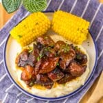 Honey BBQ Riblets Plate full of bbq riblets on top of mashed potatoes and corn on the cob.