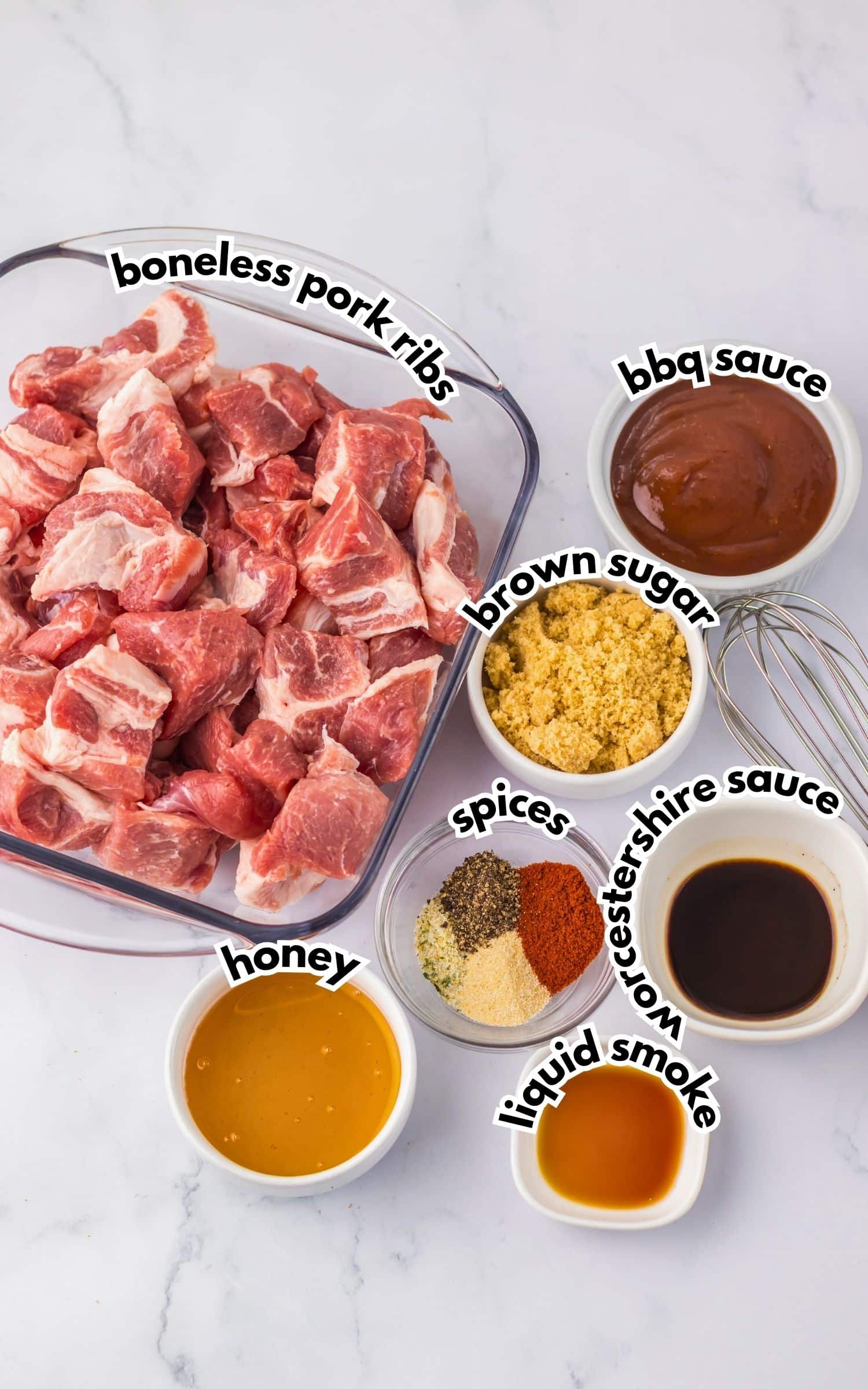 Bowls of ingredients labelled with text on a counter.