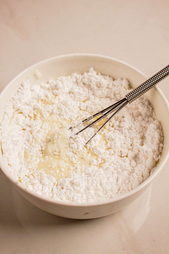 Glaze being mixed in a white bowl.