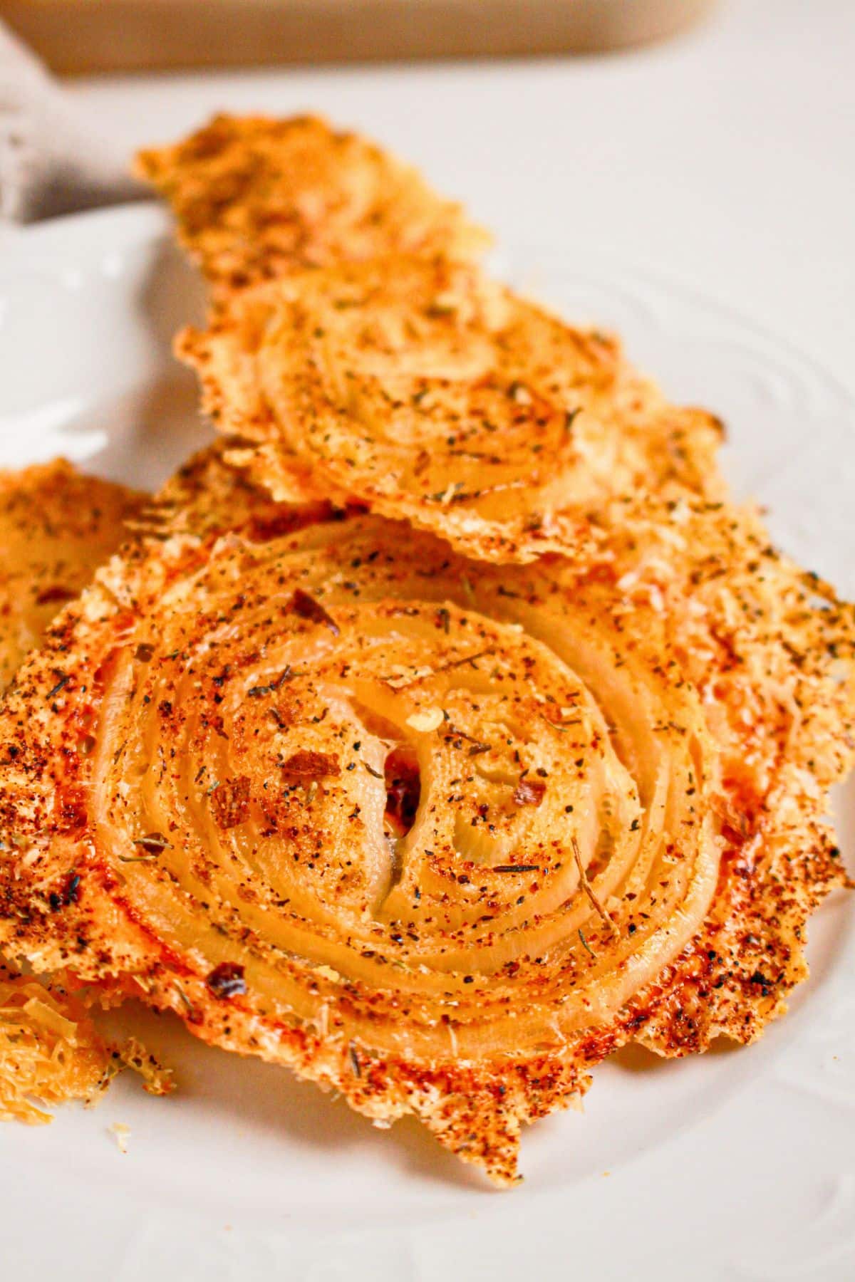 Onion ring chips on a white plate.