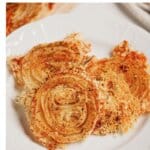 Onion ring chips on a white plate.