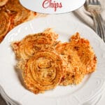 Onion ring chips on a white plate.