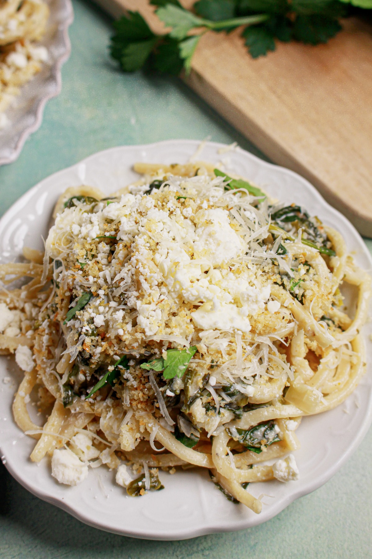 Spanakopita topped with parmesan on a plate.