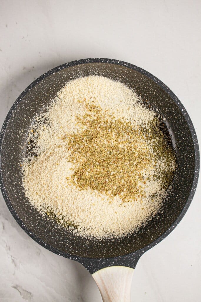 Breadcrumbs being toasted in a skillet.