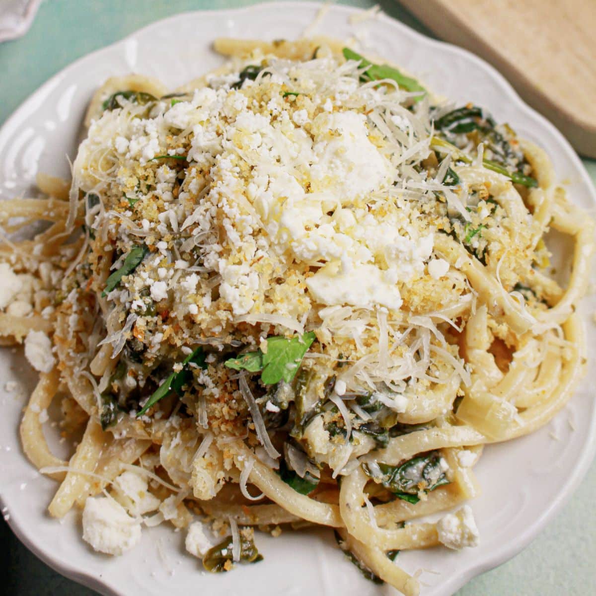 Spanakopita topped with parmesan on a plate.