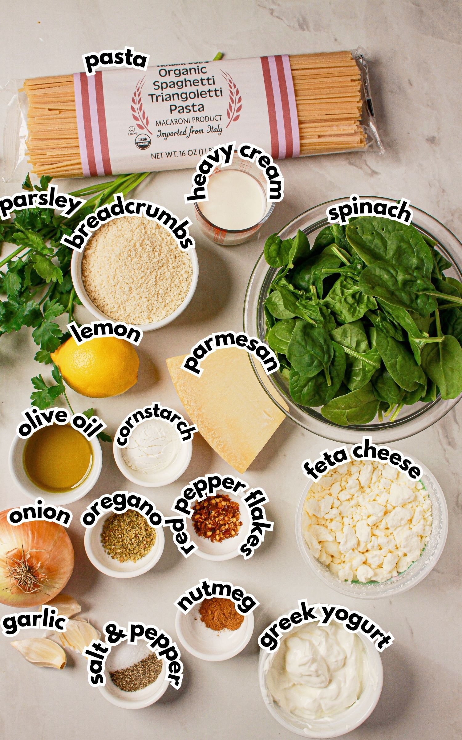 Bowls of ingredients labelled with text on a counter.