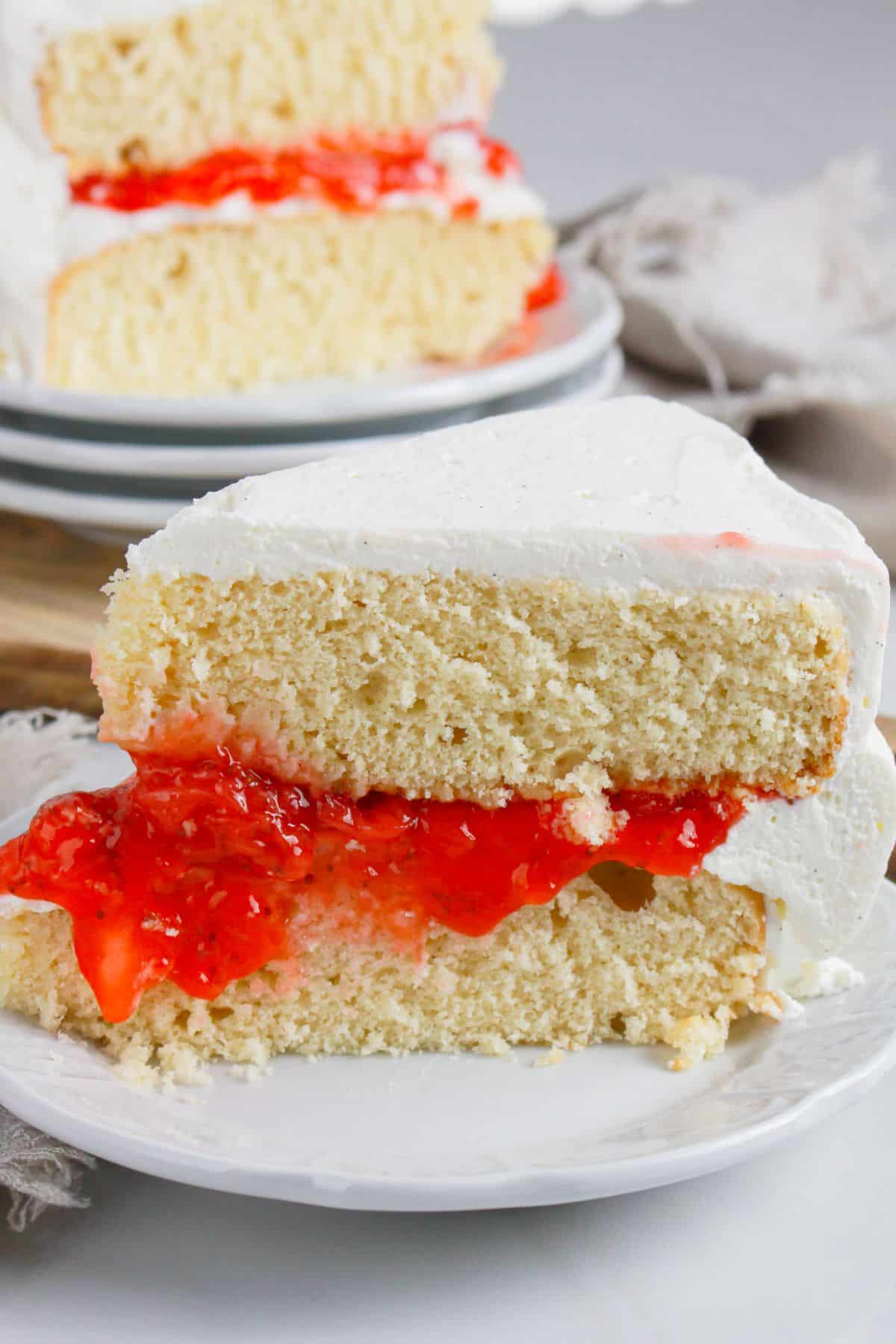 Slice of strawberry shortcake cake on a plate.