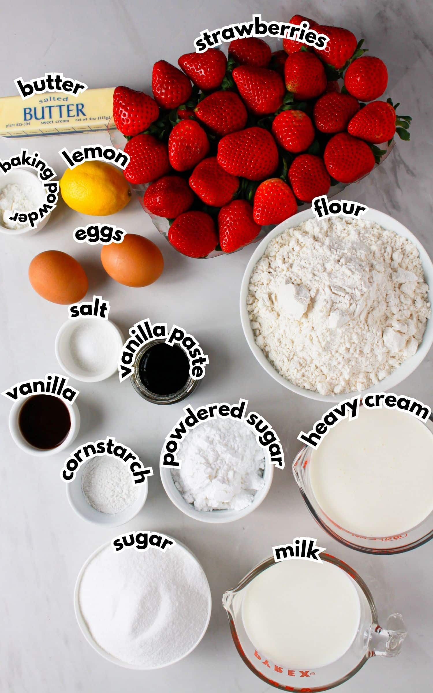 Bowls of ingredients labelled with text on a counter.