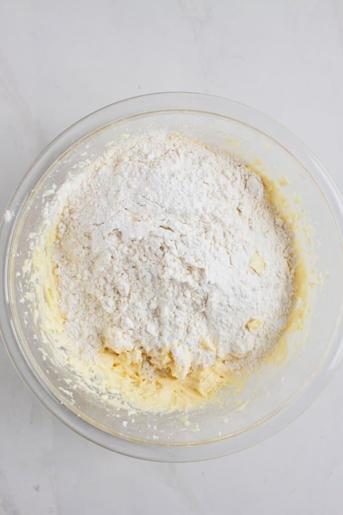 Large glass bowl full of cake batter.