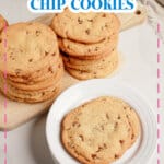 Stack of thin chocolate chip cookies on a wooden cutting board.
