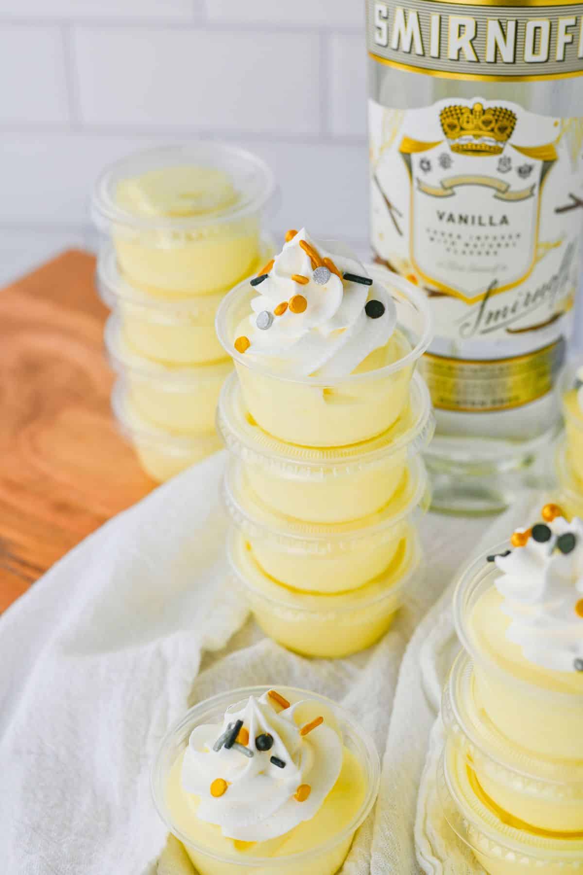 Vanilla pudding shots on a white napkin.