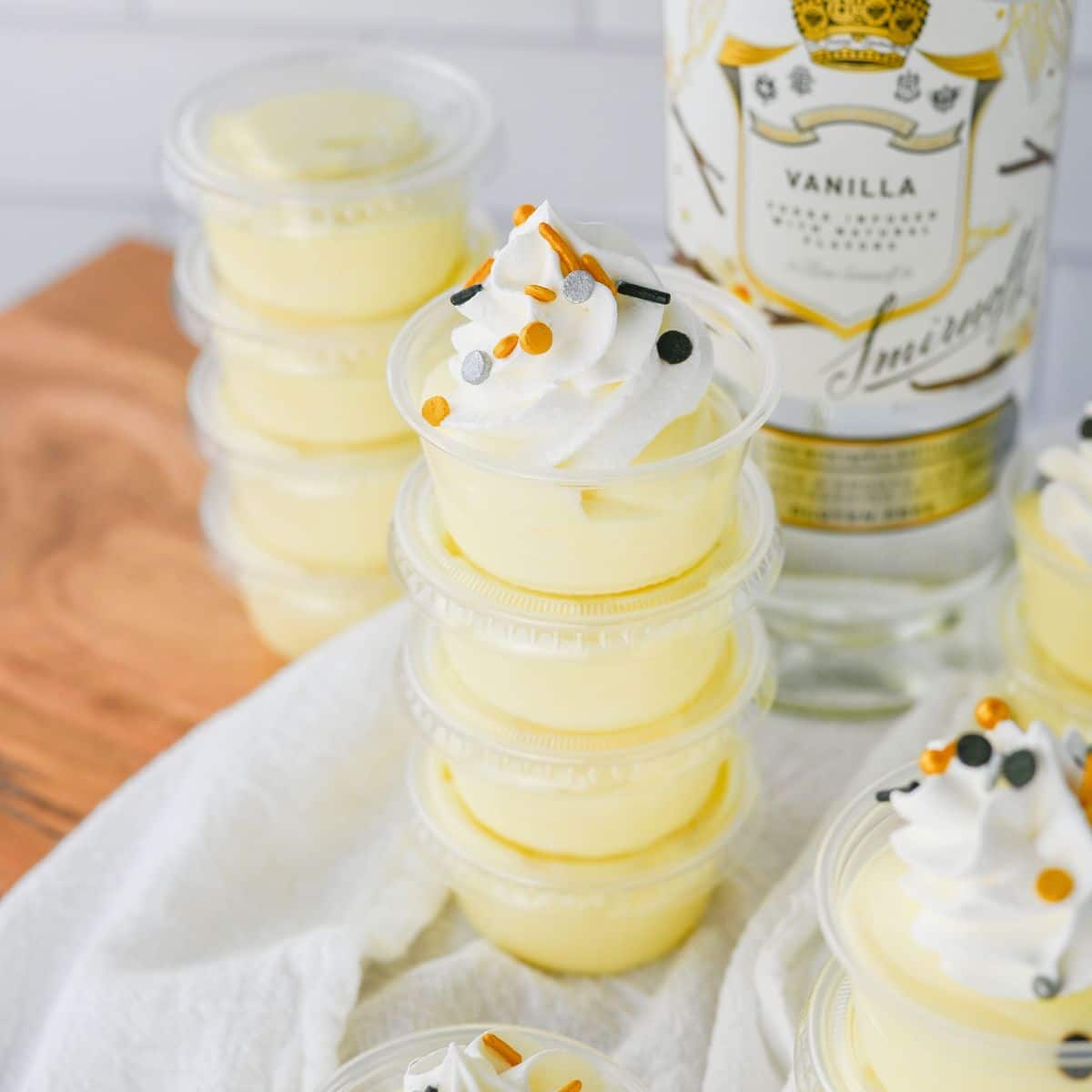 Vanilla pudding shots on a white napkin.