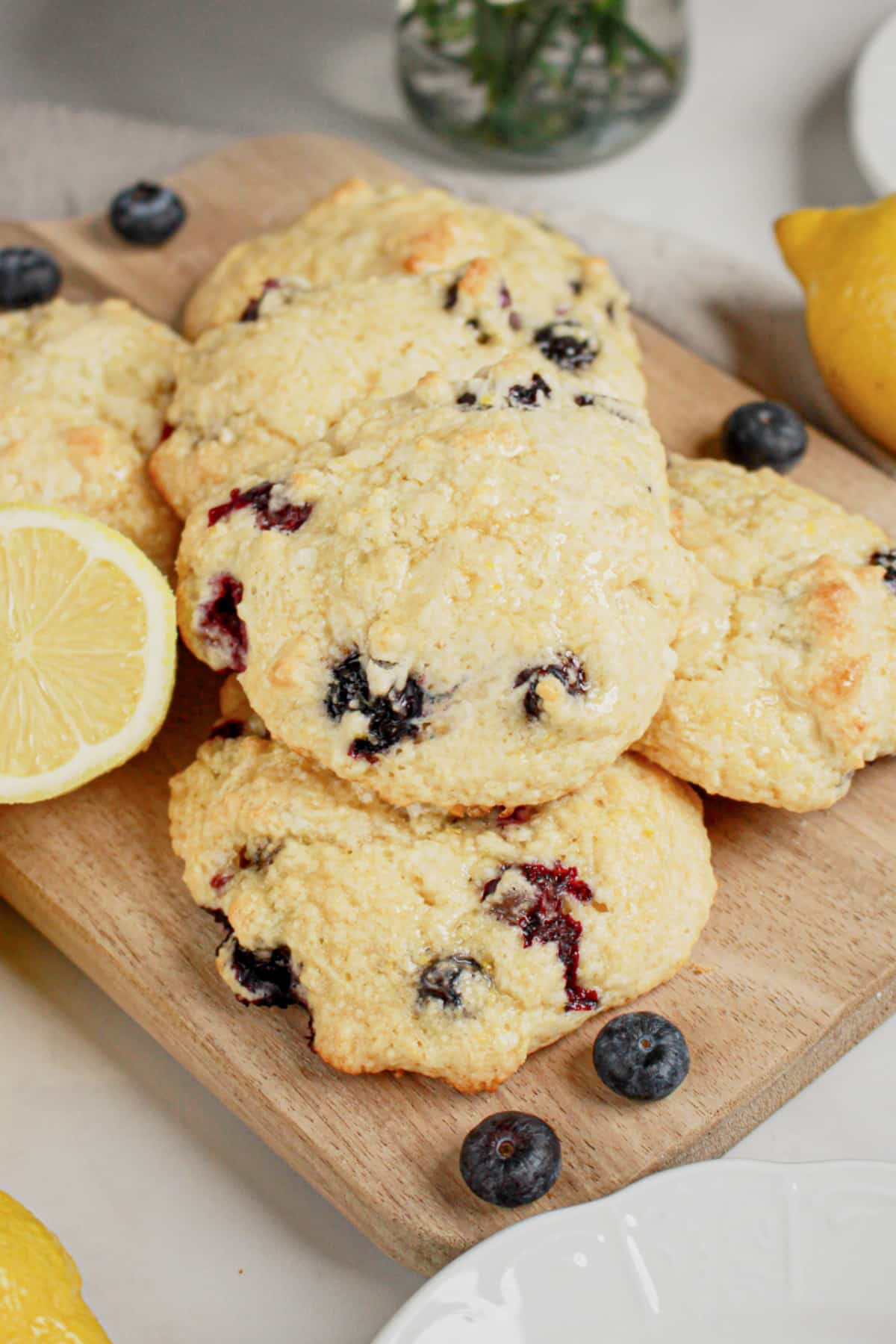 Blueberry and lemon scones on a wooden cutting board.