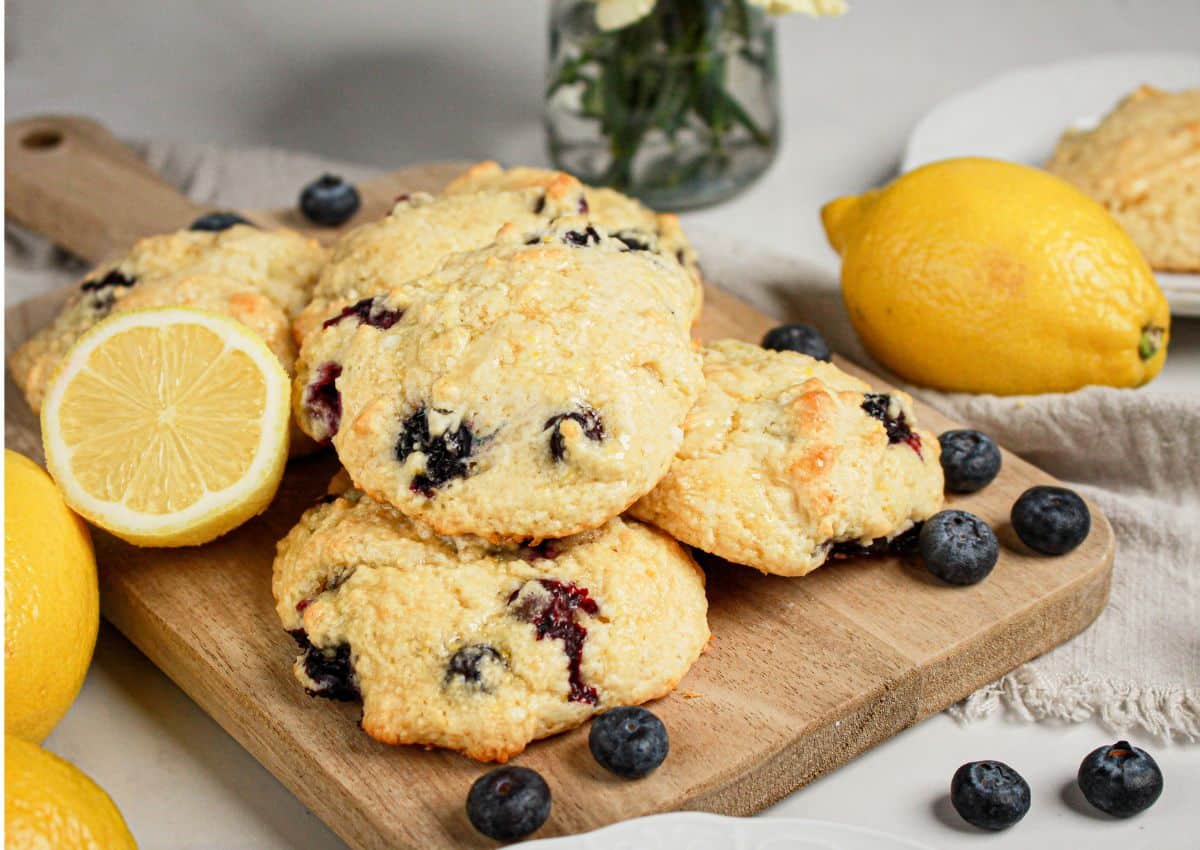 Blueberry and lemon scones on a wooden cutting board.