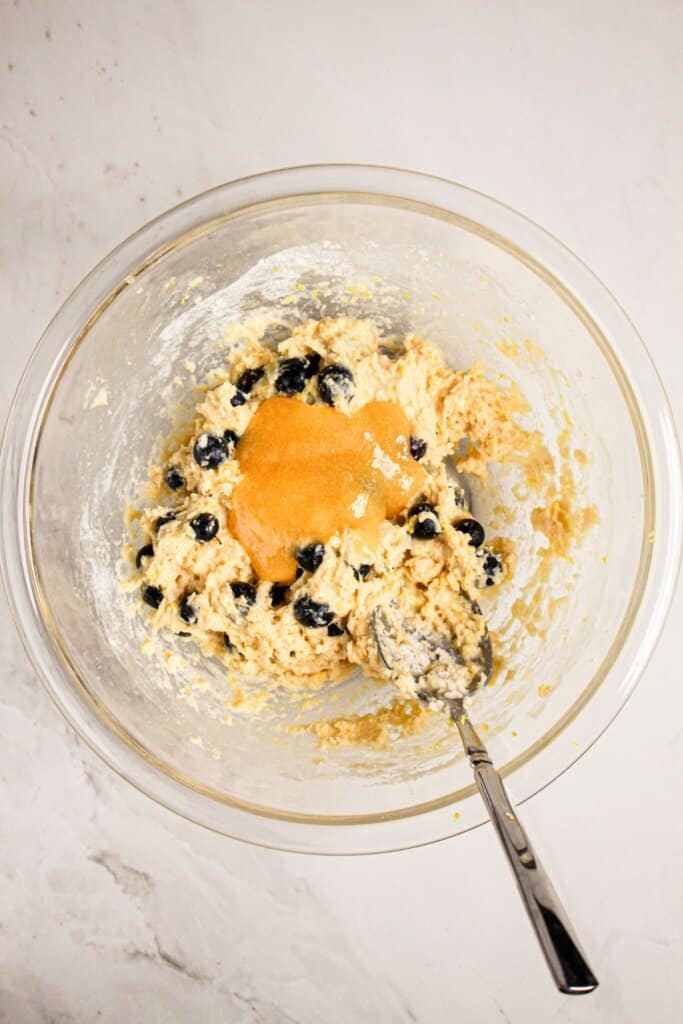 Lemon curd being mixed in a bowl.