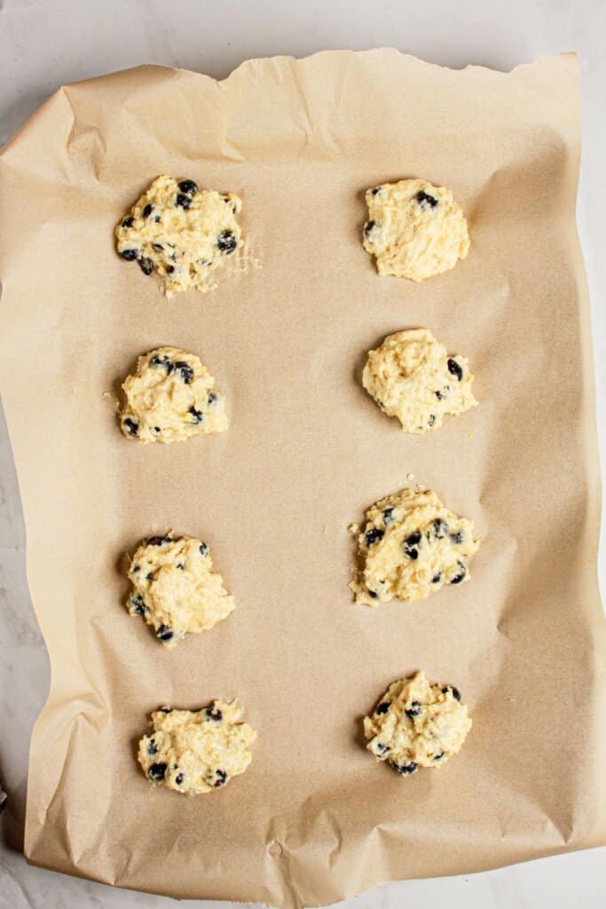 Scones on a parchment lined baking sheet.