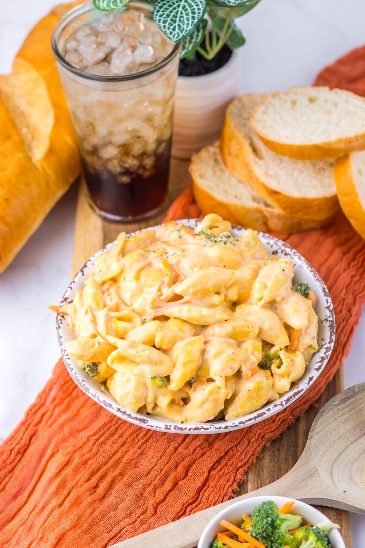 White bowl full of broccoli mac and cheese.