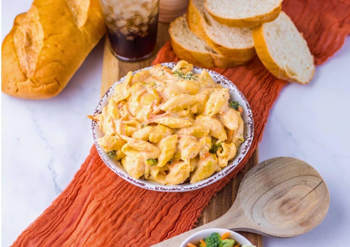 White bowl full of broccoli mac and cheese.
