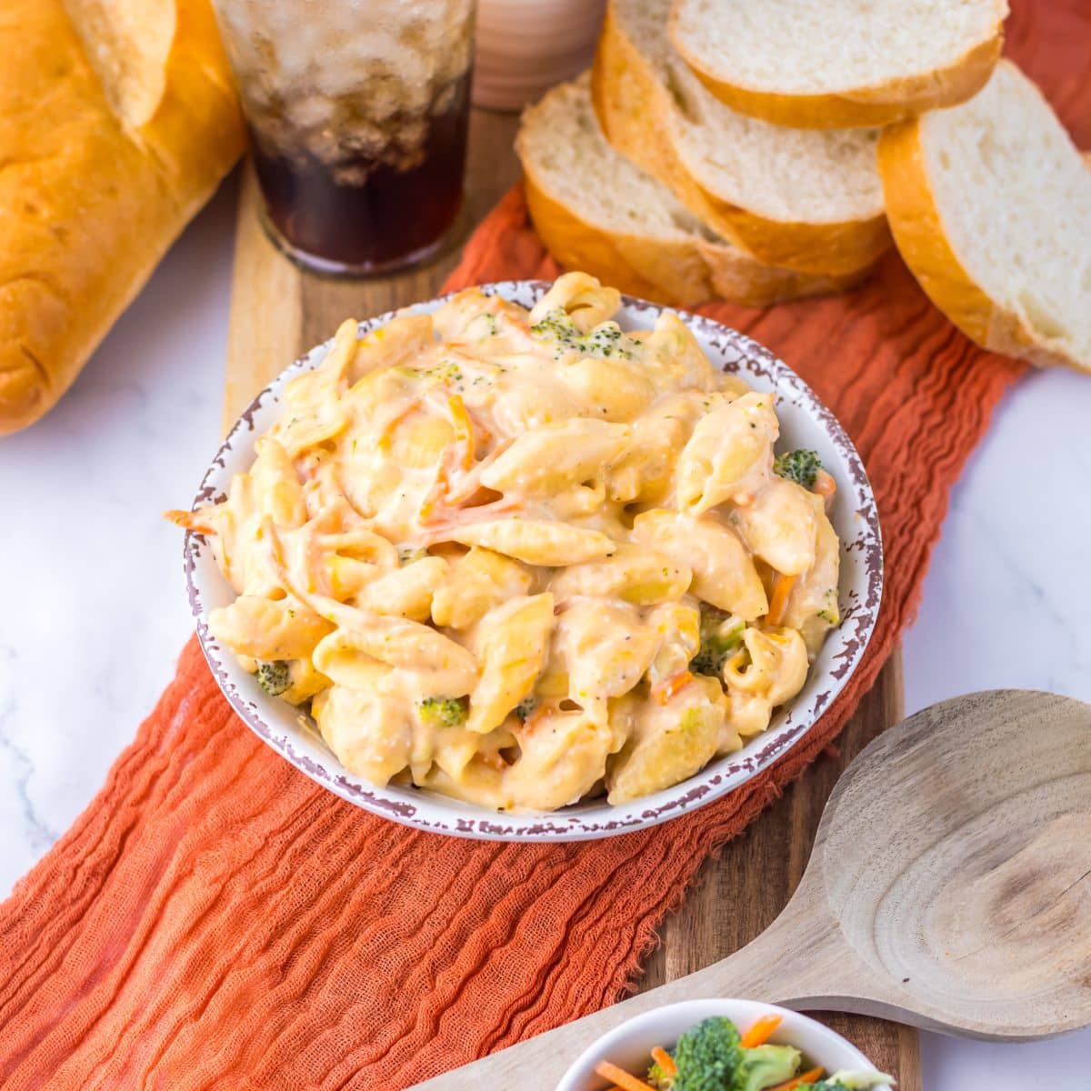 White bowl full of broccoli mac and cheese.