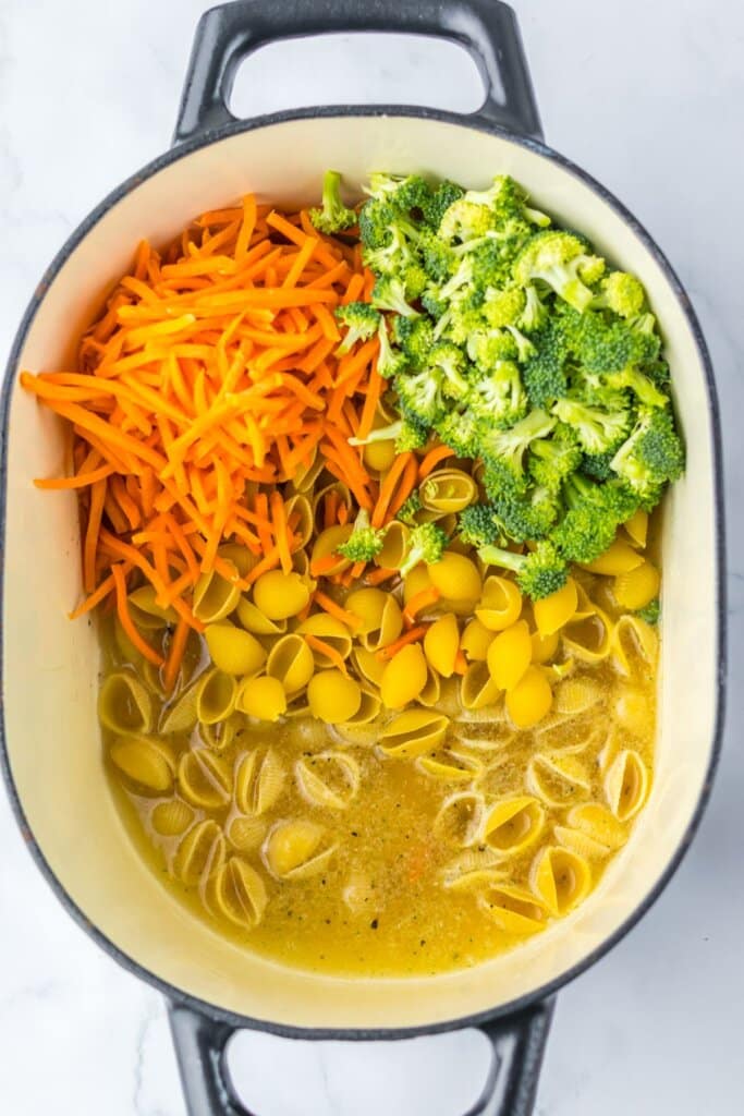 Pasta and veggies in a large pot.