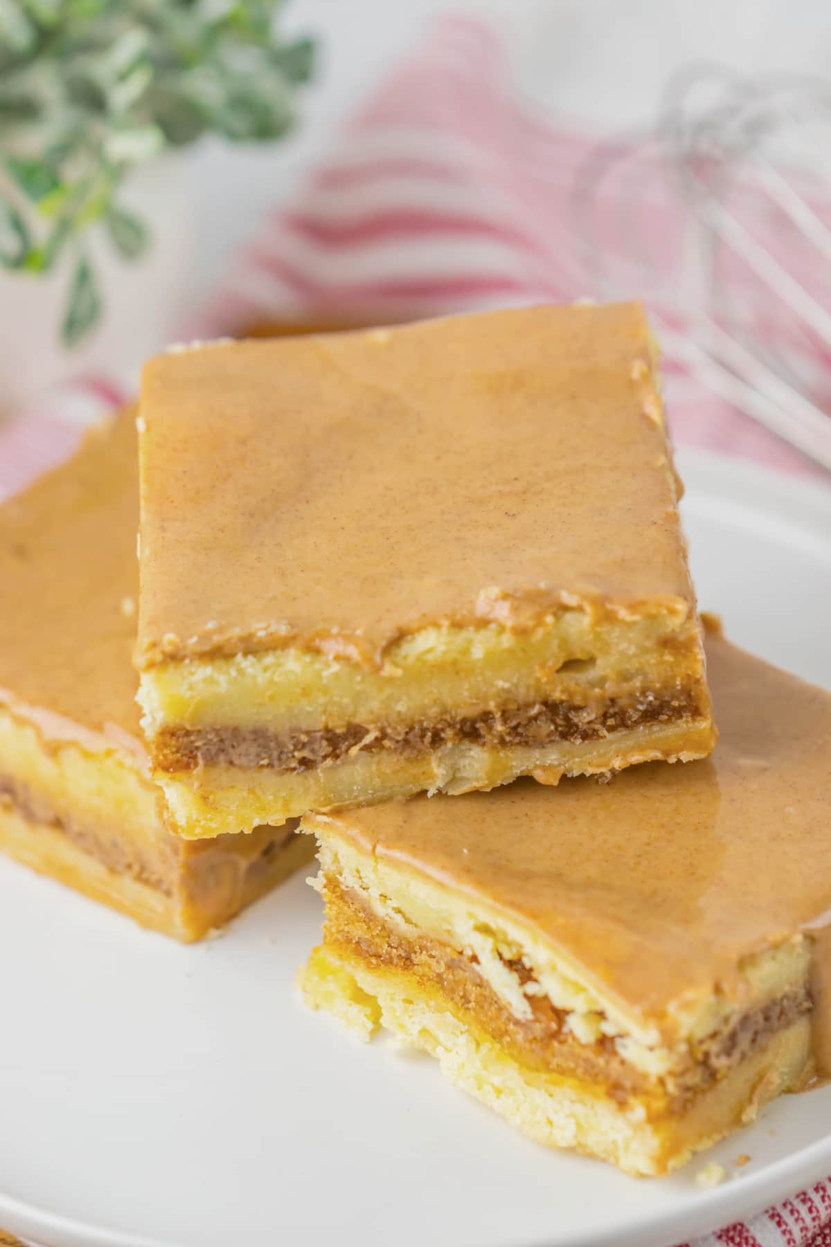 Three brown butter cinnamon bars on a small plate.
