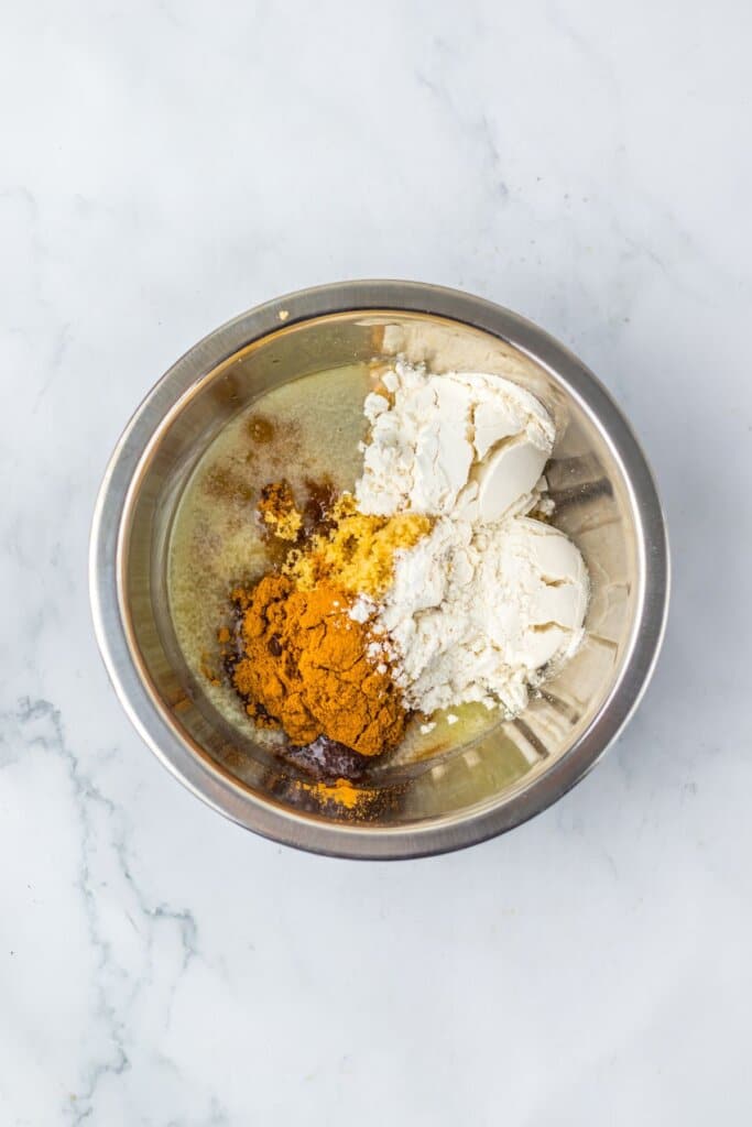 Filling ingredients being mixed in a stainless steel mixing bowl.