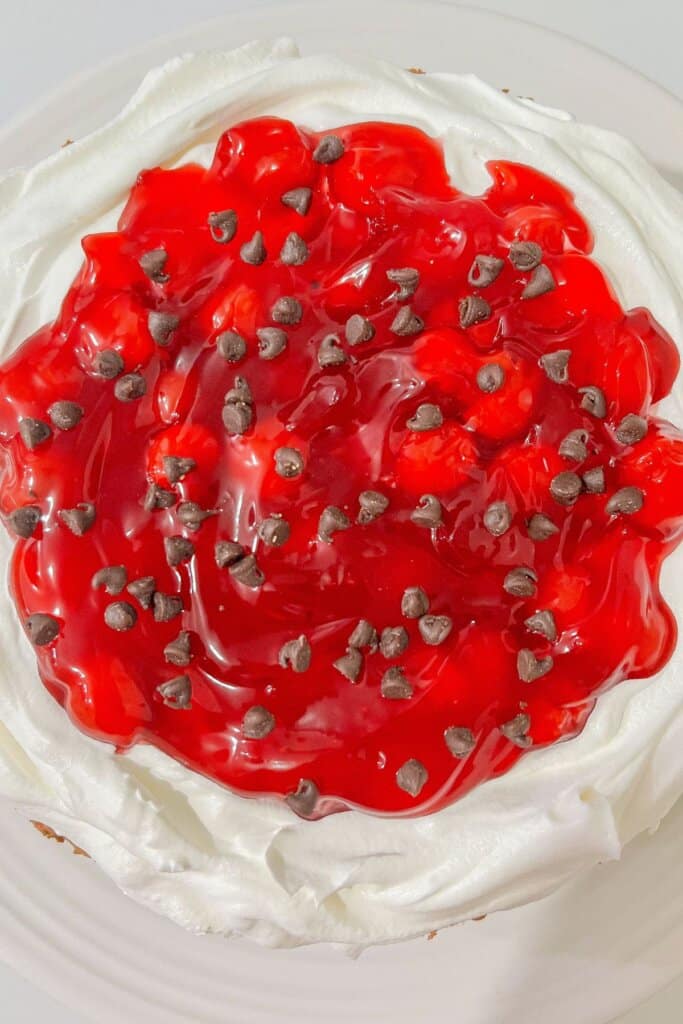 Pie filling being added on top of dessert.