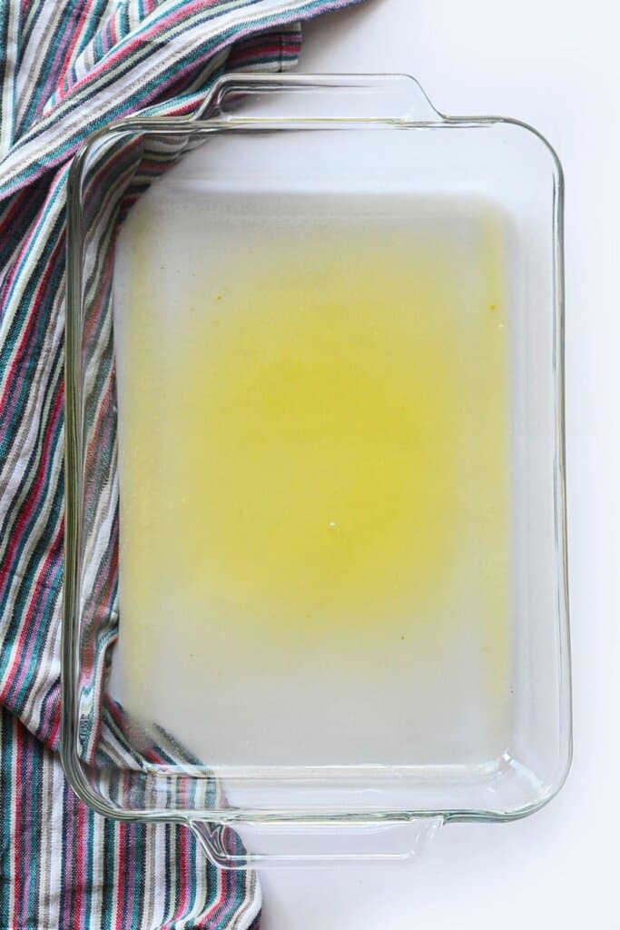 Melted butter in a glass baking dish.